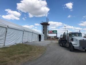 Construction Tents Next to Large Trucks - American Pavilion