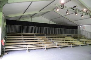 American Pavilion clearspan tent with bleachers for a corporate presentation. Losberger, tent bleachers, rental lighting   
